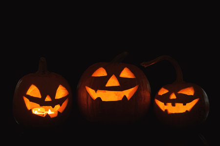Halloween pumpkin heads. Glowing jack lanterns in darkの写真素材