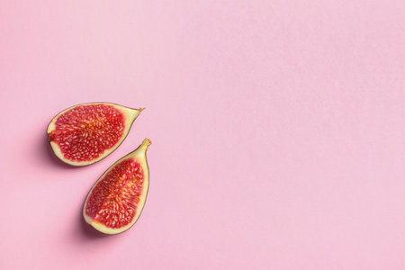 Fresh ripe fig slices on color background, top view. Space for textの写真素材