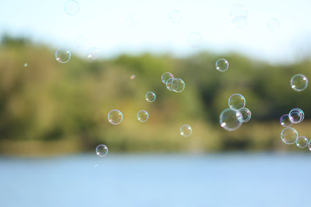 Beautiful translucent soap bubbles outdoors on sunny day