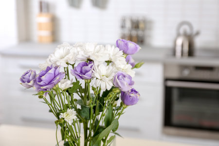Vase with beautiful flowers in kitchen interiorの写真素材