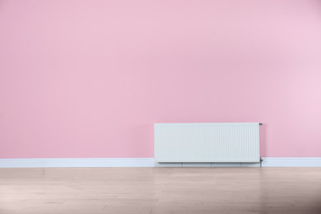 Modern radiator on color wall with space for text. central heating systemの写真素材