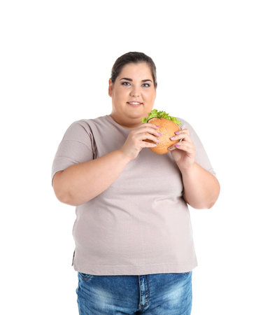 Overweight woman with hamburger on white backgroundの写真素材