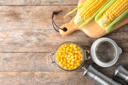 Flat lay composition with corn kernels on wooden background. Space for textの写真素材
