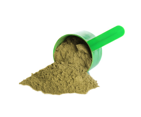 Hemp protein powder and measuring scoop on white backgroundの写真素材