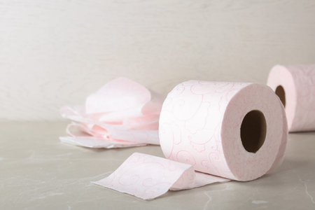 Roll of toilet paper on gray table. Space for textの写真素材
