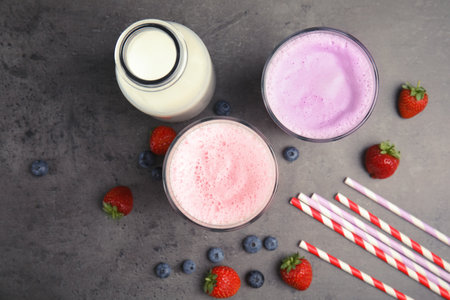 Flat lay composition with delicious milk shakes on gray backgroundの写真素材