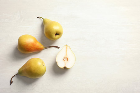 Flat lay composition with ripe pears on light background. Space for textの写真素材