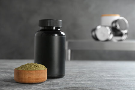 Hemp protein powder in bowl and jar on table. Space for textの写真素材