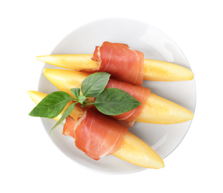 Plate with melon slices and prosciutto on white background, top viewの写真素材