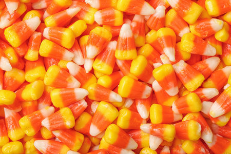 Delicious candy corns as background, top view