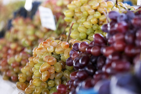 Fresh ripe juicy grapes on counter at marketの写真素材