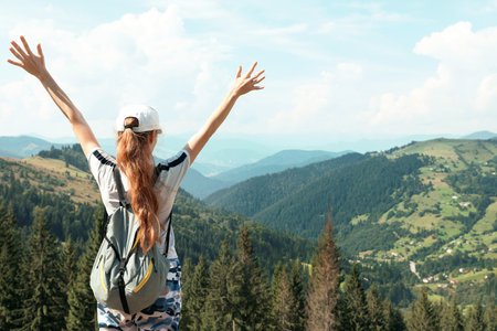 Woman with backpack in wilderness. mountain sceneryの写真素材