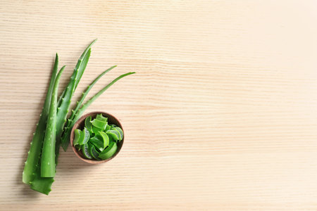 Flat lay composition with aloe vera leaves and space for text on wooden backgroundの写真素材