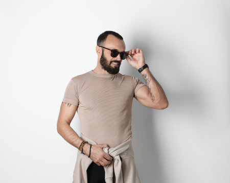 Portrait of handsome tattooed man on white backgroundの写真素材