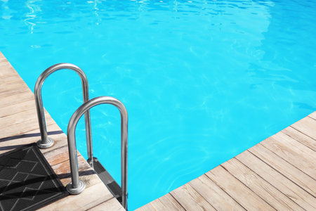 Modern swimming pool with step ladder outdoorsの写真素材