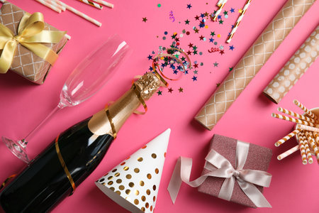 Creative flat lay composition with bottle of champagne on color backgroundの写真素材