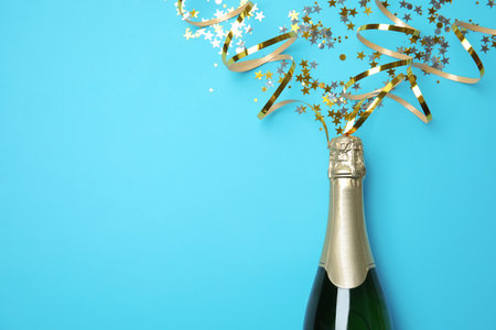 Creative flat lay composition with bottle of champagne and space for text on color backgroundの写真素材