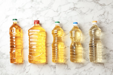 Oil bottles on marble background, top viewの写真素材