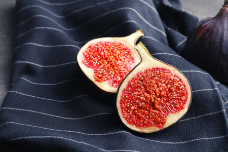 Fresh ripe sliced figs on fabric. tropical fruits