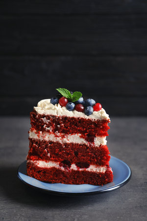 Plate with piece of delicious homemade red velvet cake on tableの写真素材