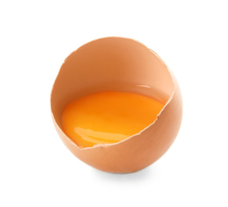 Cracked raw chicken egg with yolk on white backgroundの写真素材