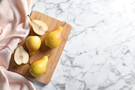 Flat lay composition with ripe pears on marble background. Space for textの写真素材