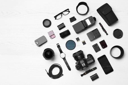 Flat lay composition with equipment for professional photographer on wooden background. Space for textの写真素材