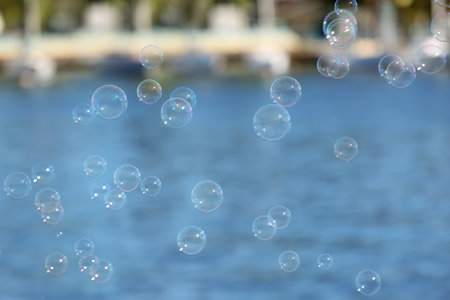 Beautiful translucent soap bubbles outdoors on sunny dayの写真素材