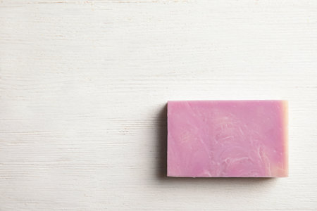 Hand made soap bar on white wooden background, top view. Space for textの写真素材