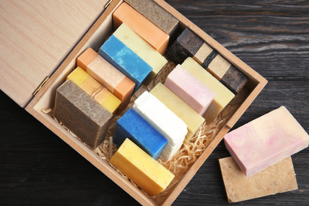 Many different handmade soap bars in wooden box on table, top viewの写真素材