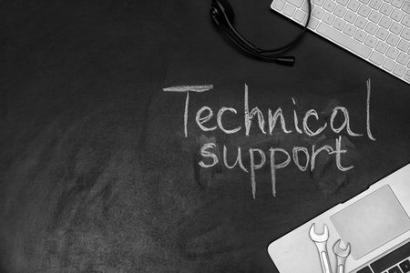 Flat lay composition with words "TECHNICAL SUPPORT" and space for text on dark backgroundの写真素材