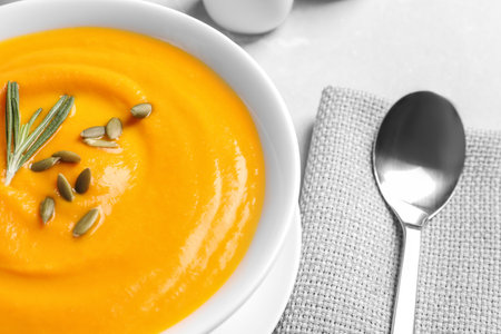 Bowl with tasty pumpkin soup served on table, closeupの写真素材