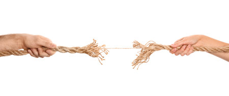 Man and woman pulling frayed rope at breaking point on white backgroundの写真素材