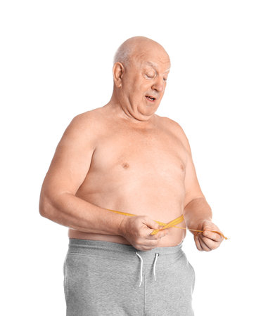 Fat senior man with measuring tape on white background. weight lossの写真素材