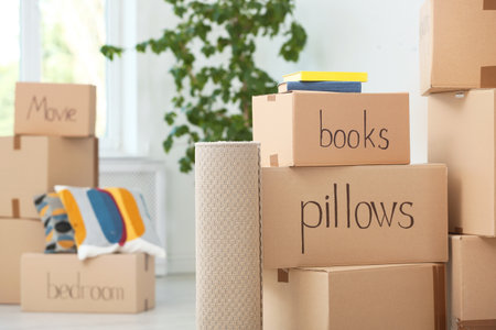 Cardboard boxes and household stuff indoors. moving day