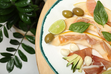 Plate with melon and prosciutto appetizer on table, top viewの写真素材