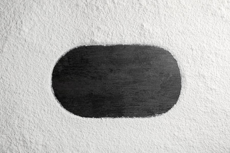 Oval frame made of flour on gray background, top view. Space for textの写真素材