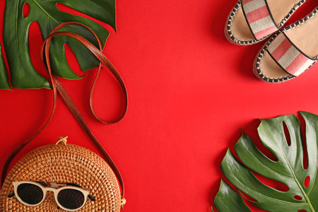 Flat lay composition with bamboo bag, beach items and space for text on color backgroundの写真素材