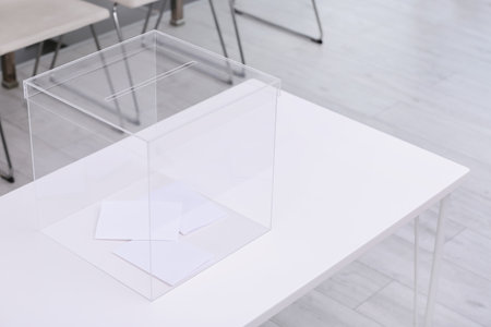 Ballot box on table at polling station. Space for text