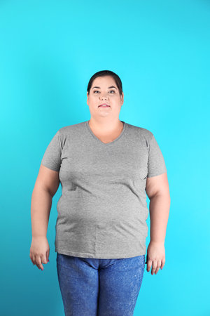 Overweight woman before weight loss on color backgroundの写真素材