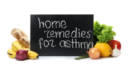 Natural products and slate board with text HOME REMEDIES FOR ASTHMA on white backgroundの写真素材