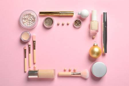 Flat lay composition with makeup products and Christmas decor on color background. Space for text