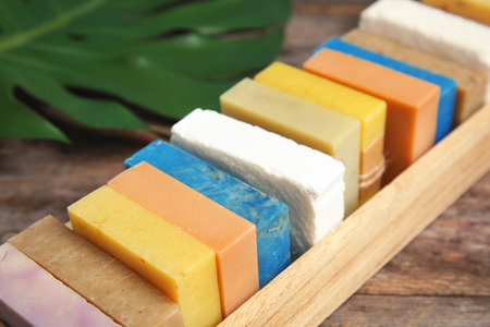 Many different handmade soap bars in wooden box on table, closeupの写真素材