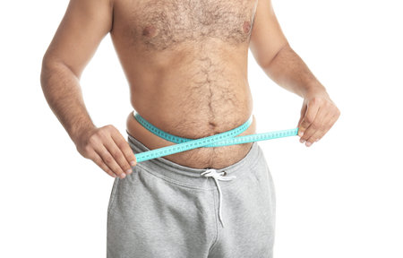 Overweight man with measuring tape on white background, closeupの写真素材