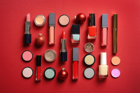 Flat lay composition with makeup products and Christmas decor on color backgroundの写真素材