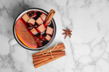 Flat lay composition with mug of hot mulled wine and space for text on marble backgroundの写真素材