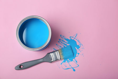 Flat lay composition with paint can and dipped brush on color background. Space for textの写真素材