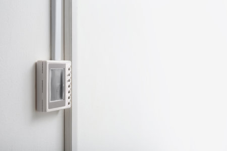 Modern thermostat and space for text on white wall. heating system