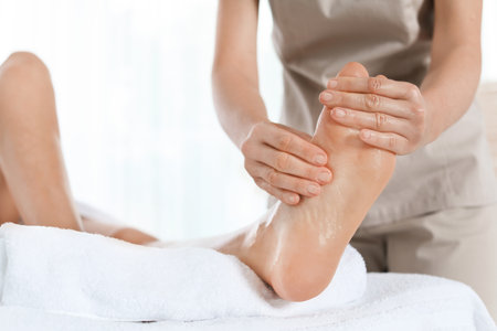 Woman receiving foot massage in wellness center, closeupの写真素材