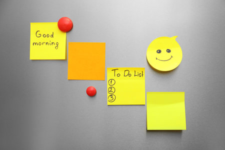 Paper sheets and magnets on refrigerator doorの写真素材